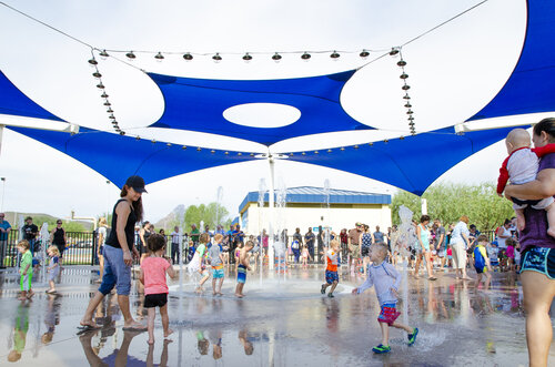 Families playing on splash pad