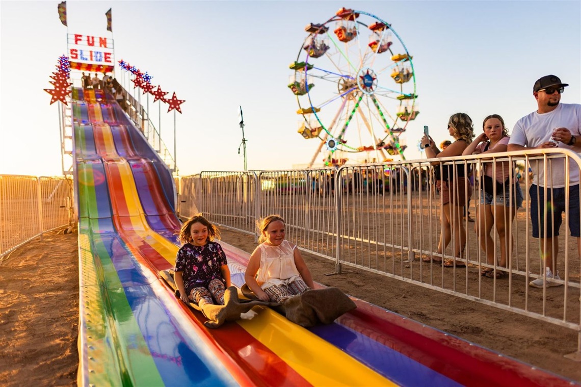 two girls on a slide at Marana's Fall Festival